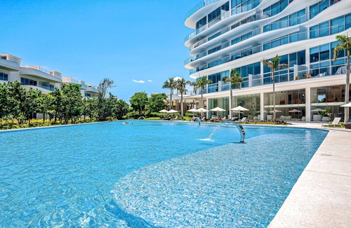 Flamingos Condo | Updated condo with sweeping views, pools, fitness room, balcony, W/D, and AC