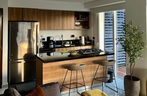 North Hotel Zone Apartment | Chic 1BR 1BA Zoho Skies condo with rooftop pool stunning views