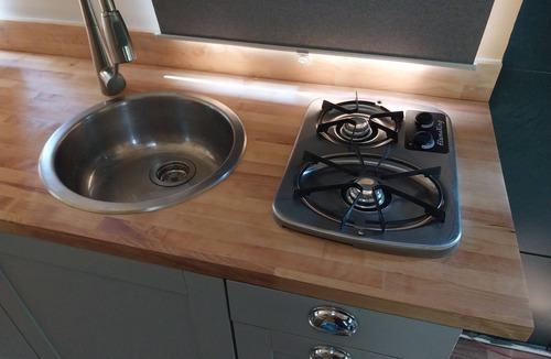 Larkspur House | Cozy camper by the creek, surrounded by serenity and nature.