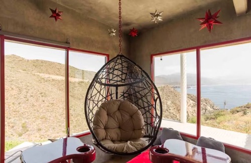 Ensenada Apartment | Eclectic Cliffside Den with Hanging Living Area