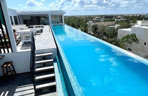 Zama Apartment | Fresh and Stylish Studio Aldea Zama rooftop pool Mya 109