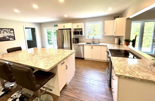 Lion's Head Cabin | Pike & Pine: This bright and spacious retreat blends modern comfort with cozy cottage charm. Featuring a fully equipped kitchen, multiple cozy bedrooms, stylish bathrooms, and inviting living spaces with a wood-burning fireplace.