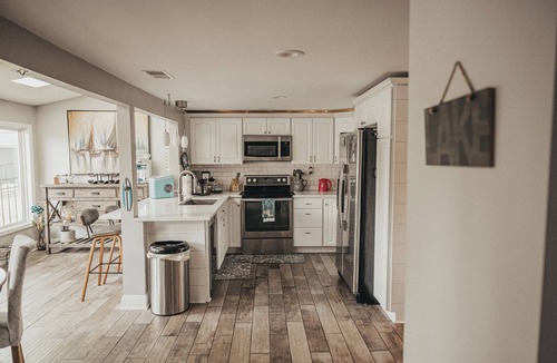 Portage Lakes Cottage | SLICE OF HEAVEN lake front cottage with HOTTUB, fire pit, kayaks & Dog friendly!