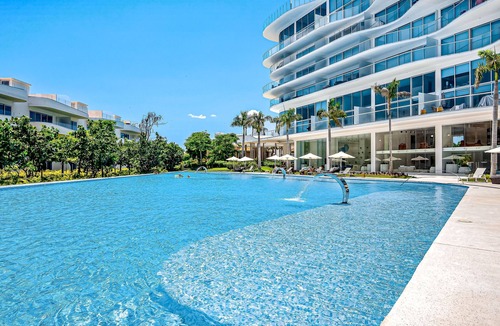 Flamingos Condo | Updated condo with sweeping views, pools, fitness room, balcony, W/D, and AC