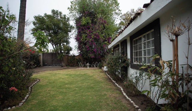 House with garden in front of the Pyramid of Cholula, Puebla,MX