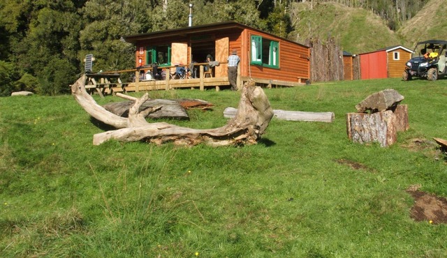 Private log cabin in valley.