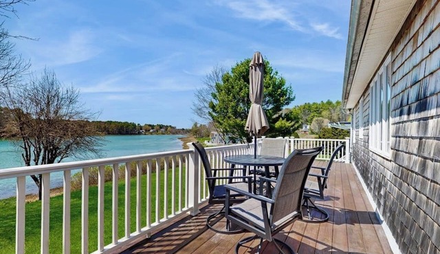 Tranquil waterfront home with stunning views, a spacious deck, and a BBQ grill