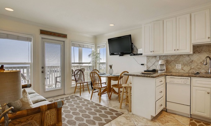Galveston Condo | Beach Cottage steps from Surf. fishing. the Beach and Serene Sunsets (1303)
