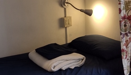 1 bed in 6 bed female dorm room with shared bathroom